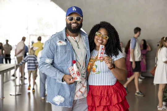 A couple inside The Broad holding their photobooth photo strip